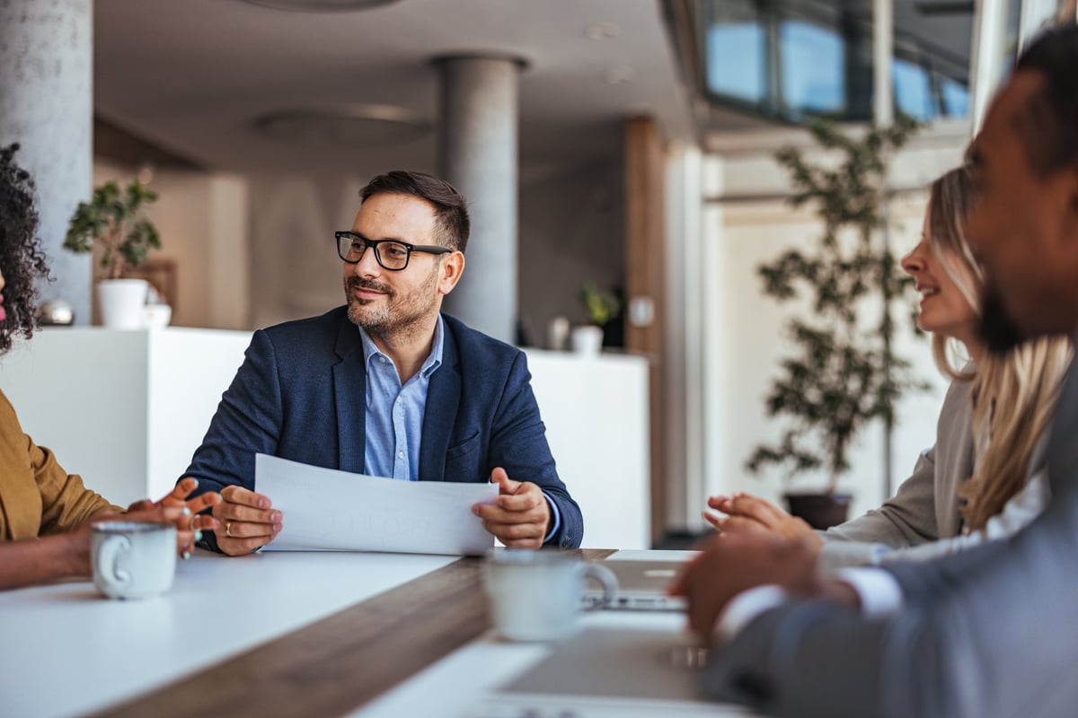 A diverse team in a planning meeting around a table in a bright modern office